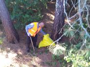 Man with litter pick up bag.