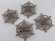 Wooden sherrif's badges with "Ring Security" and various names on them