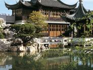 Traditional Chinese architecture, trees, and a pond at Lan Su Chinese Garden