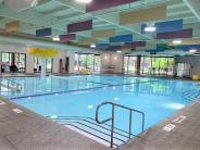 A swimming pool with decorations and a fountain at Shute Park Aquatic & Recreation Center