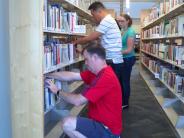WelchAllyn employees shifting the nonfiction collection in the library