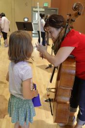 Cellist talks with young person