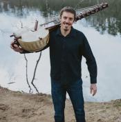 Musician Sean Gaskell holding a kora