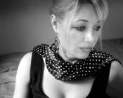 A black and white photograph of vocalist Heather Keizur looking pensive