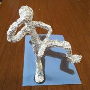 A human figure sculpted in aluminum foil