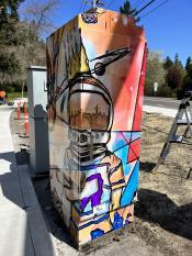 image of a traffic signal box wrapped with art