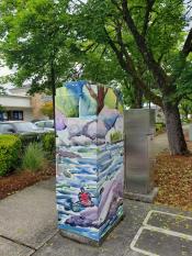 image of a traffic signal box wrapped with art