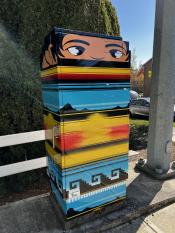 image of a traffic signal box wrapped with art