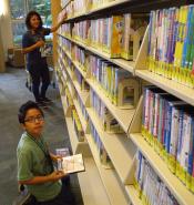 Mother and son shelving videos.