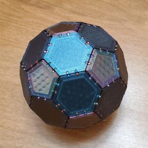 Photo of small, dark, multi-sided, three-dimensional shape built from magnetic polygons.