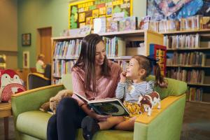A parent and child reading stories together in the Children's Room