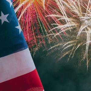 US flag against background of fireworks.