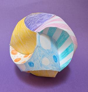 Photo of globe made from folded paper.