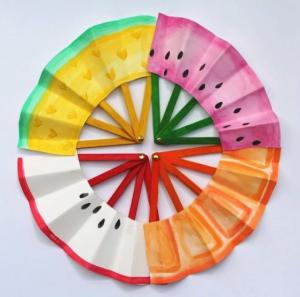 Photo of 4 folding fans made with  colorful popsicle sticks and paper to look like fruit slices.