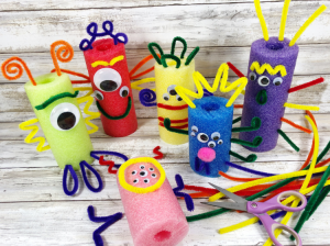 Photo of colorful "noodle monsters" made with pool noodles, googly eyes, and pipe cleaners.
