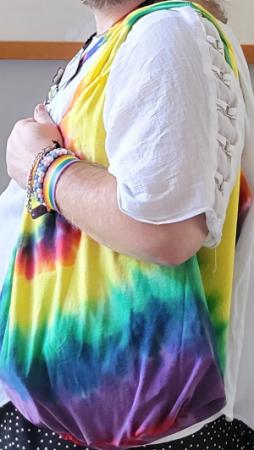 Photo of person holding shopping bag made from rainbow tie-dyed t-shirt