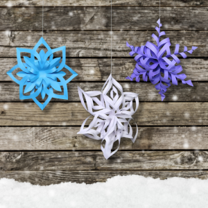 Photo of blue, white and purple snowflakes made by cutting, folding, and rolling paper.