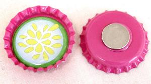 Photo of a pink and green magnet made from a bottle cap.