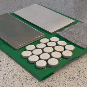 Photo of texture zoo; various textured objects attached to a felt background.