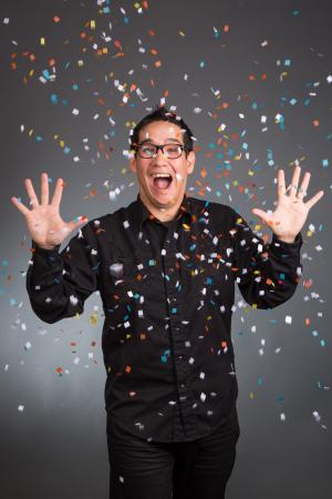 Photo of performer Louie Foxx with confetti raining down around him. 