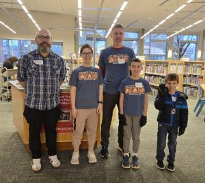 Two adults and three children from a Scout troop that served at a prior Spruce Up.