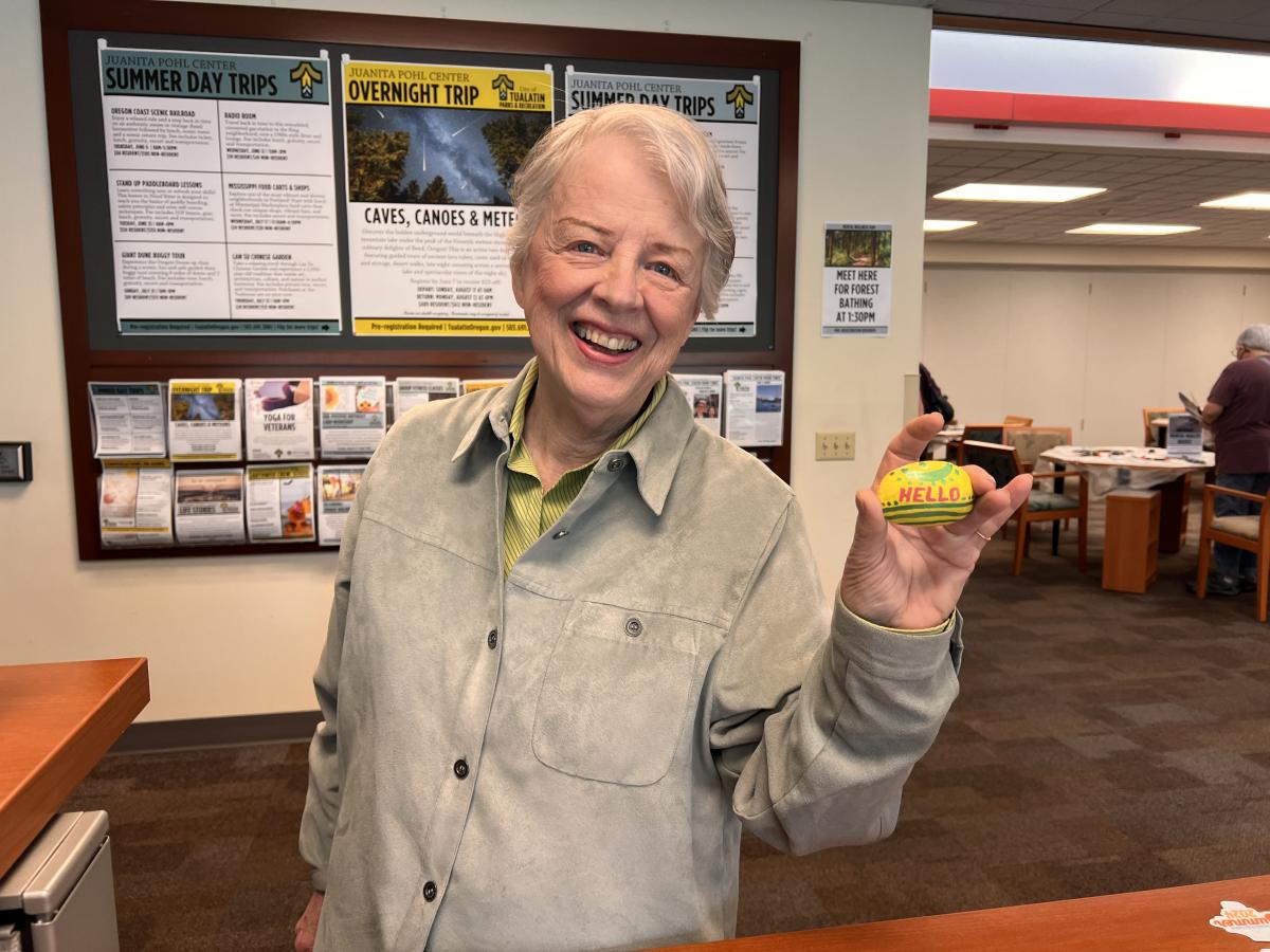 Older adult holding painted rock